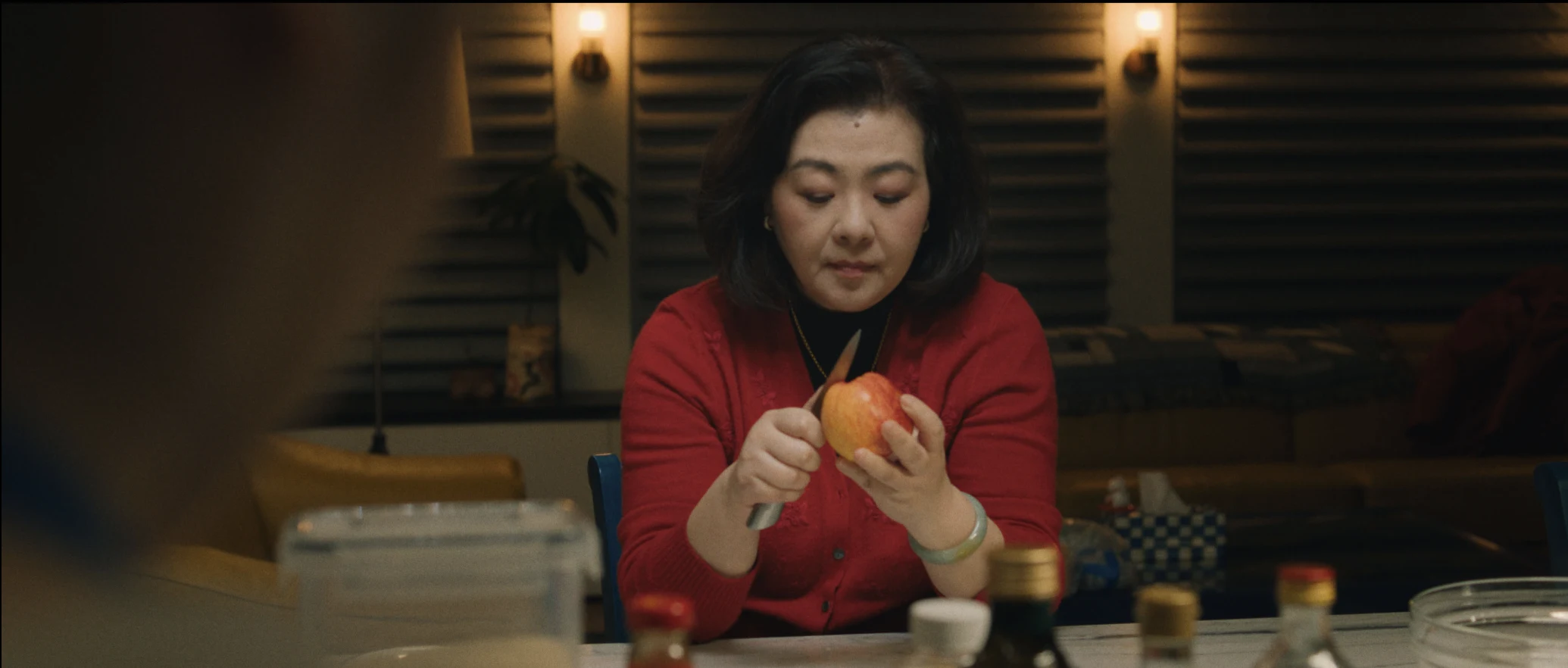 still shot from DID YOU EAT YET? a mother peels an apple