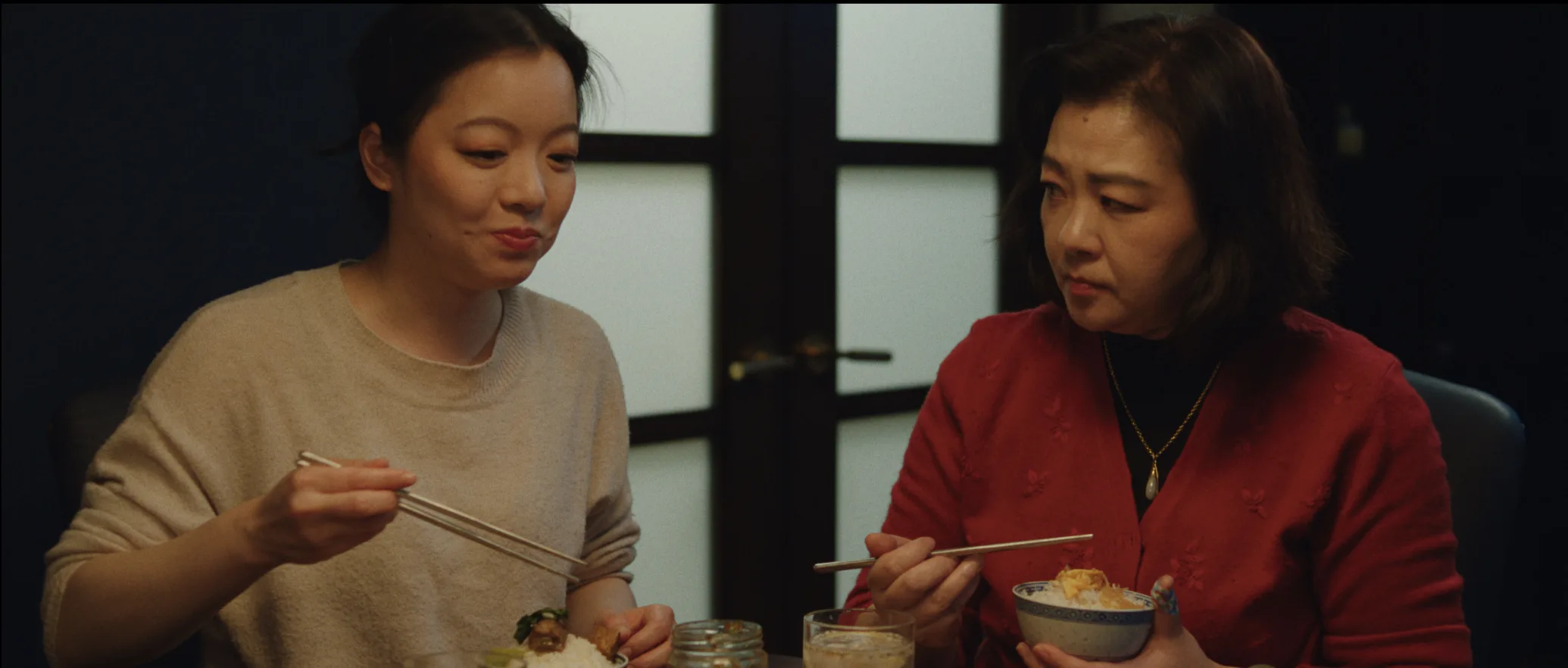 still shot from DID YOU EAT YET? a mother and daughter eat dinner together