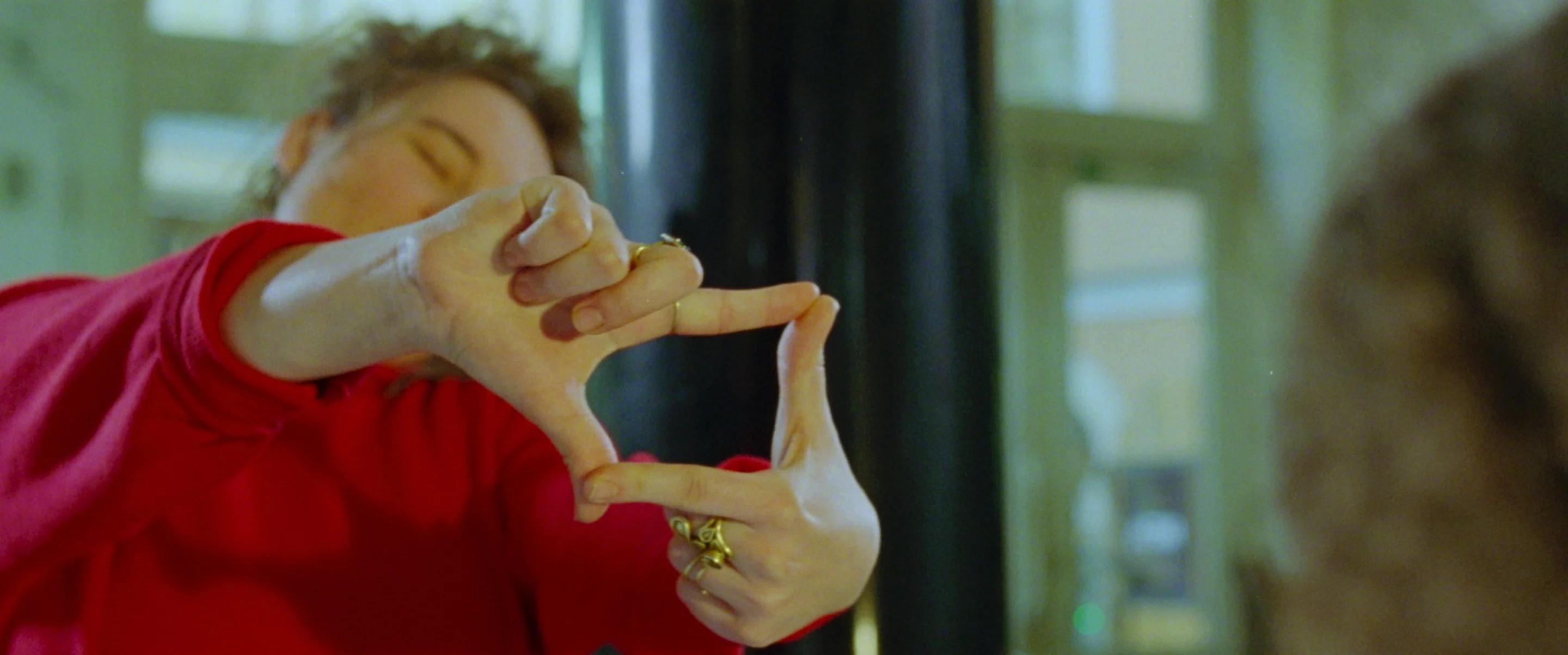 still shot from PAPERLIKE a girl making a square with her hands