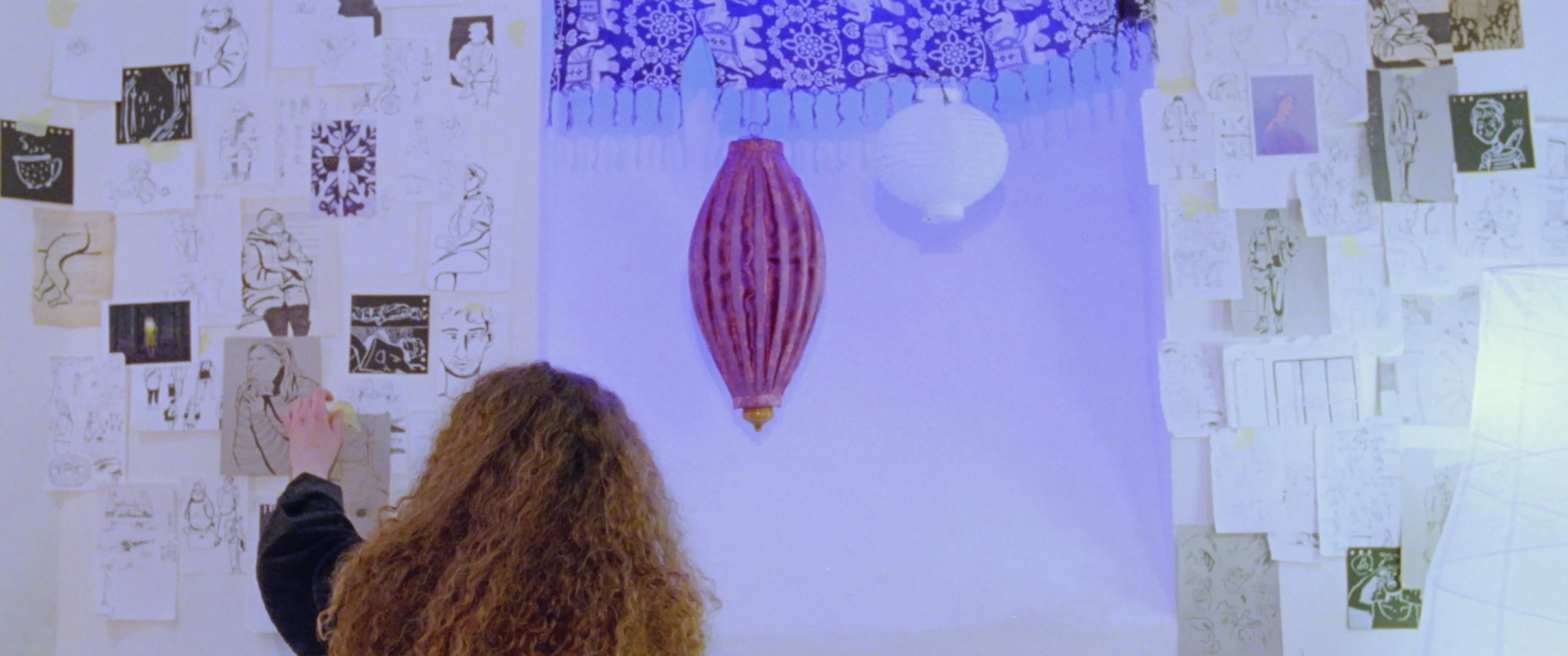 still shot from PAPERLIKE sticking various illustrations on her wall